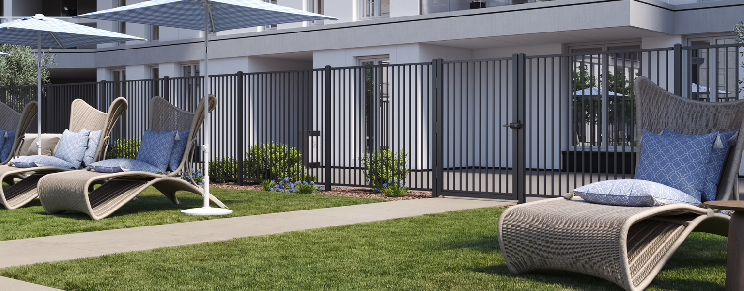 Multifamily pool space with ornamental aluminum fence.